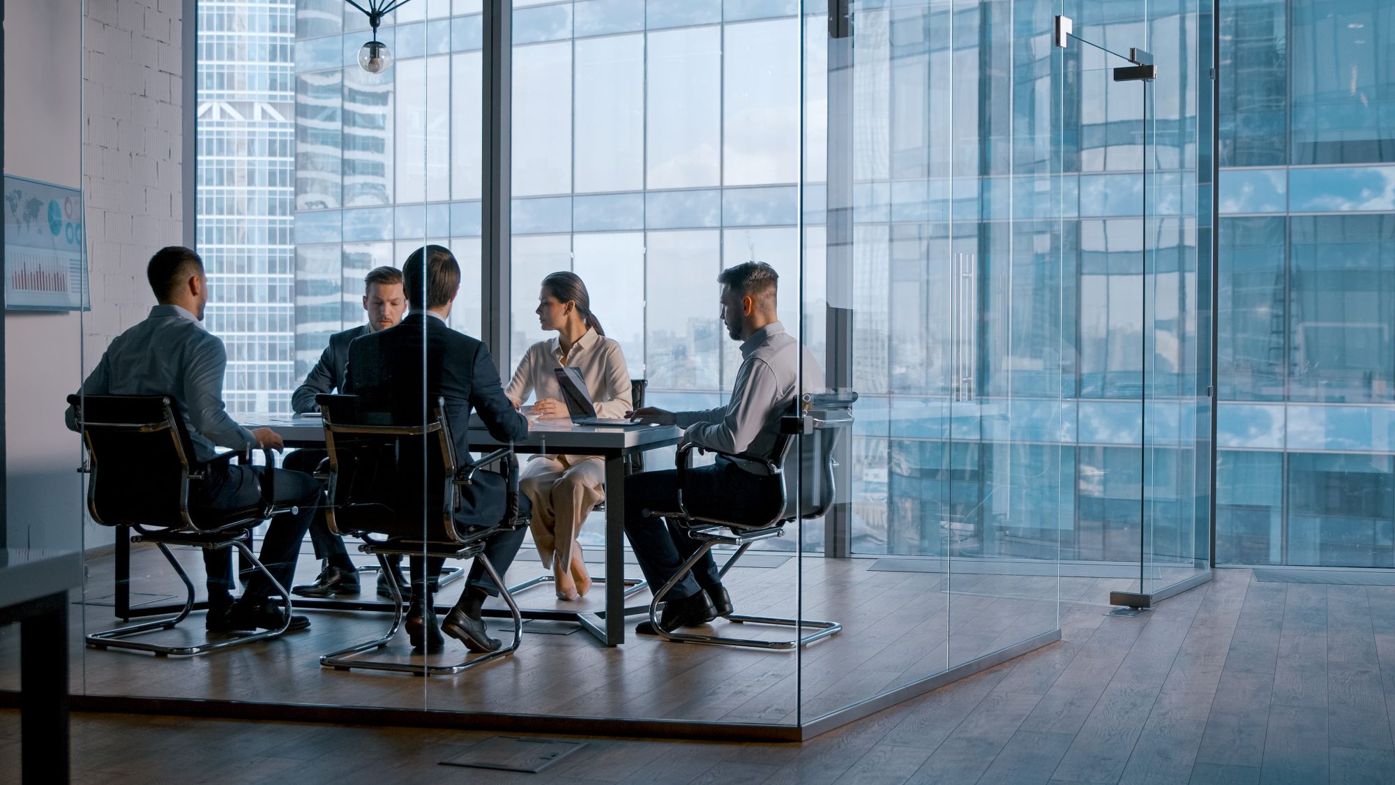 business team working in glass conference room